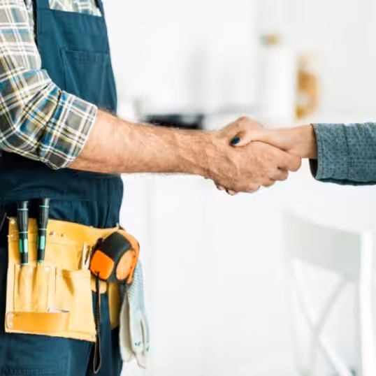 a plumber and woman shaking hands