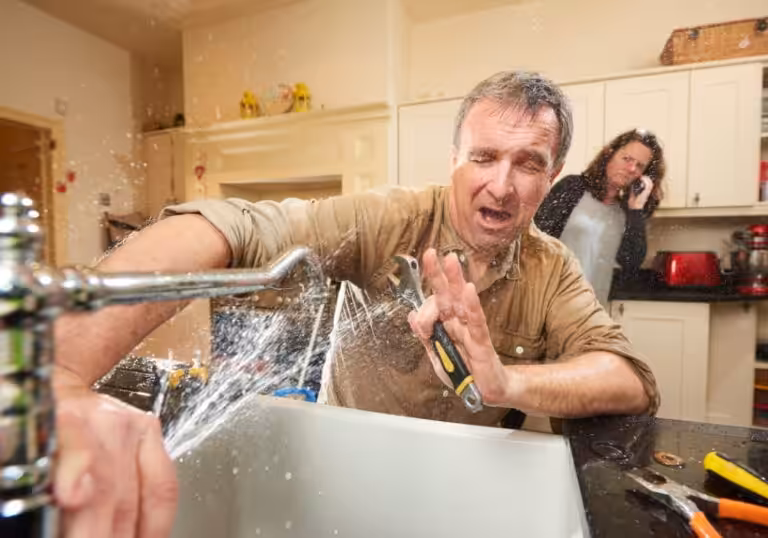 a plumber tries to stop the leak